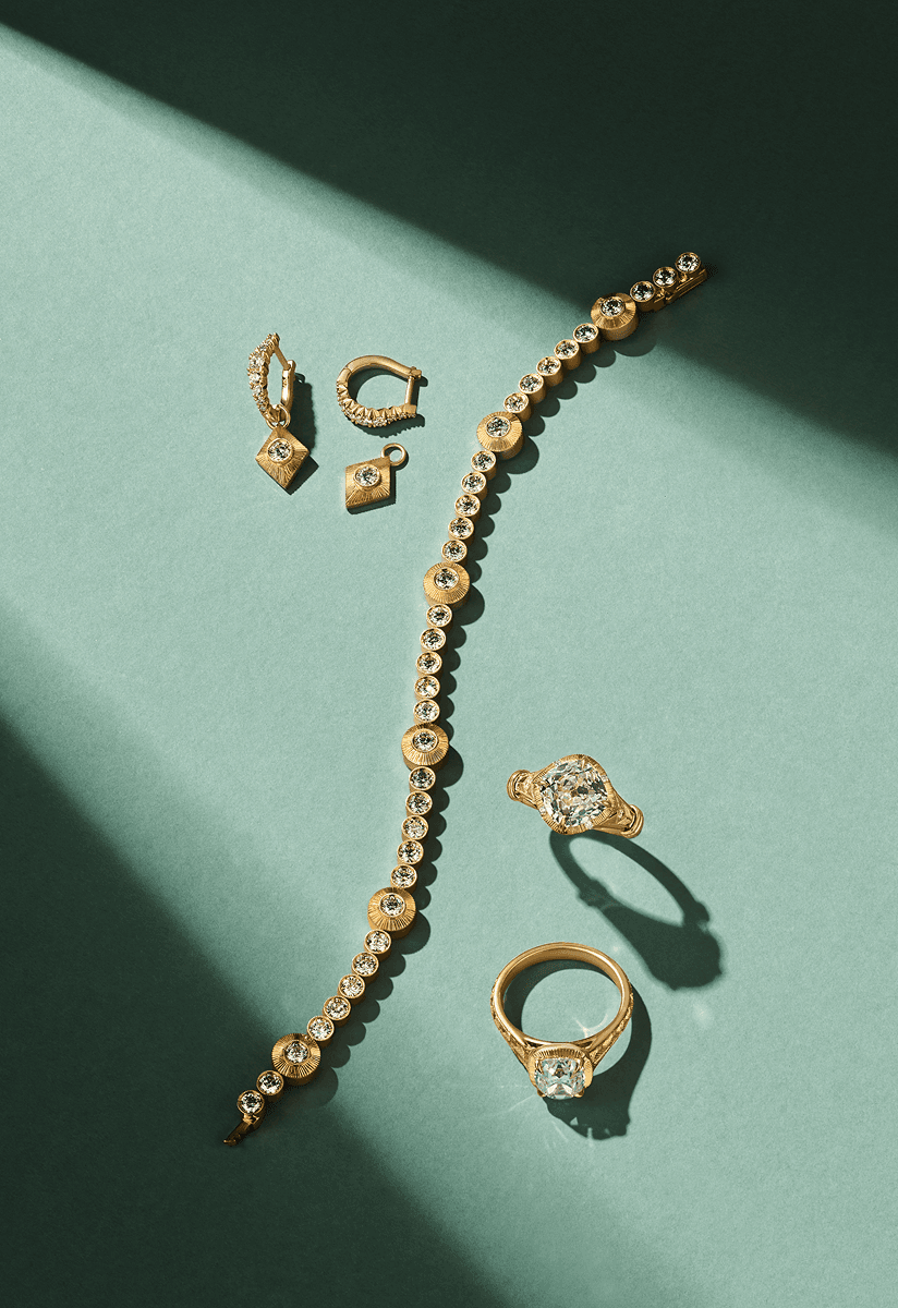Editorial still life of fine jewellery on a green surface