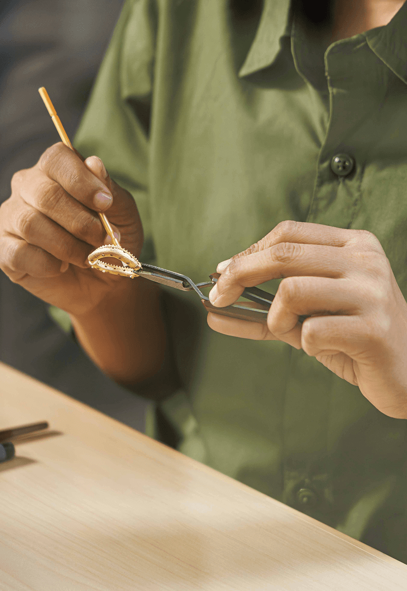 Artisan crafting jewellery at the workbench